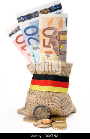 Coins in front of a little coarse jute bag with Euro banknotes Stock Photo