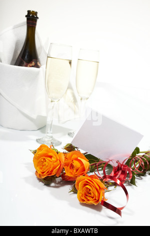 Bottle of wine with glasses and red roses on pink background. Valentine ...