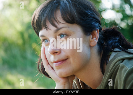 Woman smiling and looking away Stock Photo