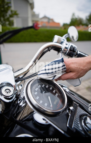 Close-up of man cleaning vintage motorbike Stock Photo