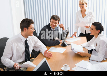 Group of young smiling professionals discuss an ideas in the office Stock Photo