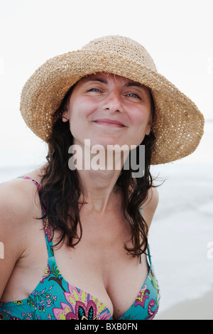Woman wearing straw hat smiling, portrait Stock Photo