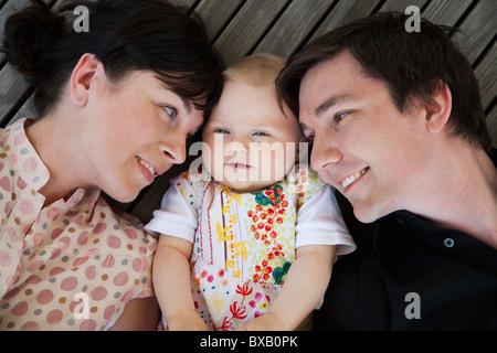 Baby girl lying between father and mother Stock Photo