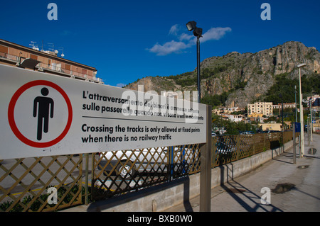 Warning at Cefalu centrale the main train station platforms with La Rocca in background Cefalu town Sicilia Italy Europe Stock Photo