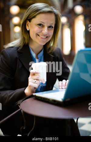 Mid-adult woman using laptop Stock Photo