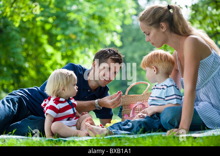 Mid adult parents with children on picnic Stock Photo