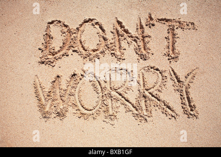 Text dont worry written on sand Stock Photo