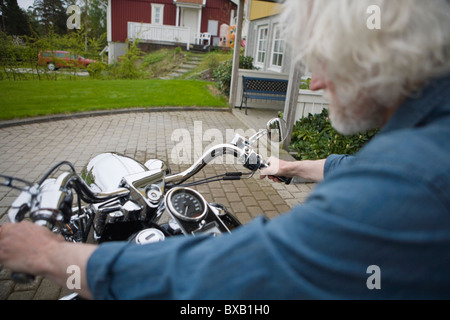 Man riding vintage motorbike Stock Photo