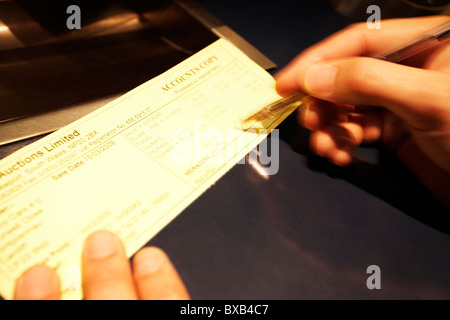 Close up of a man signing a cheque. Stock Photo