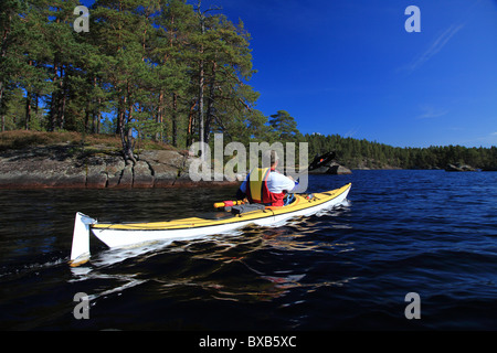 Man kayaking on lake Stock Photo