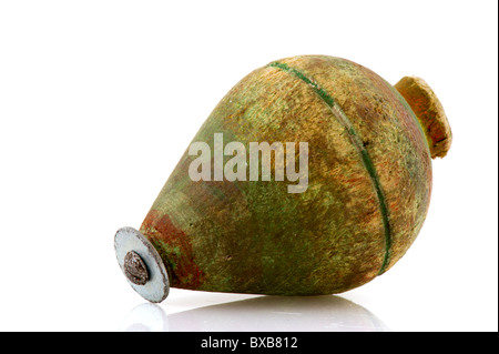 One old green paintless spinning top isolated over white Stock Photo