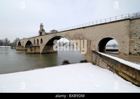 Pont d'Avignon, Pont Saint-Bénézet or Avignon Bridge & Saint Nicholas Church over River Rhône Under Snow, Avignon, Vaucluse, Provence, France Stock Photo