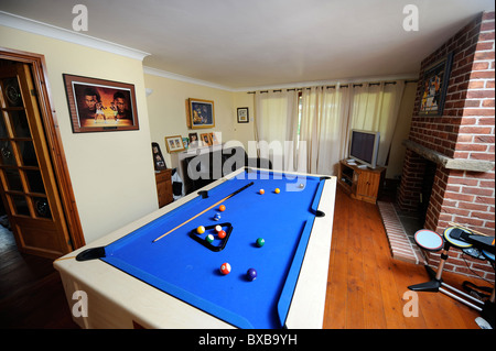 A Games Room With Pool Table In Front Of A Family The Father Is