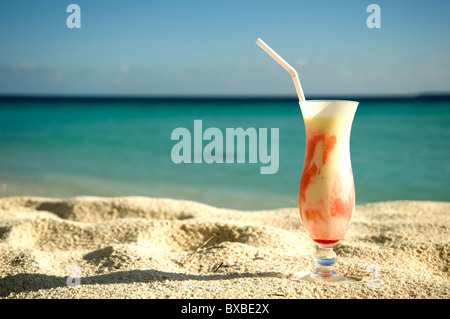 Milk and fruit cocktail on the sand Stock Photo