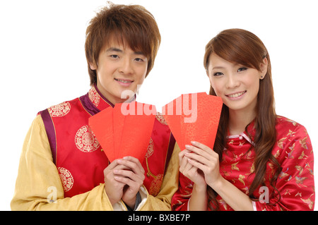 Couple holding red envelopes and smiling Stock Photo