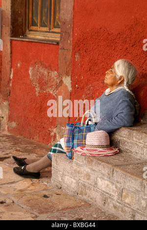 Elderly indigenous woman taking a nap in San Miguel de Allende, Guanajuato, Mexico. Stock Photo