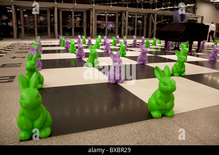 Plastic easter bunnies on a floor chessboard in Stary Browar, Poznan, Poland Stock Photo