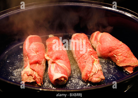 Beef roulades, fried in a roasting dish. Stock Photo