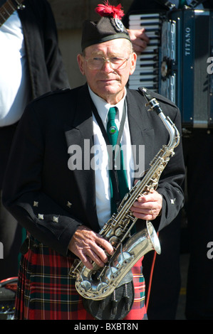 Saxophonist performing with a Highland pipe band, Dunedin, New Zealand Stock Photo