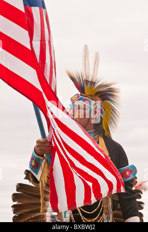 Adult male native warrior (First Nations), with American flag, at pow-wow, Blackfoot Crossing Historical Park, Alberta, Canada Stock Photo