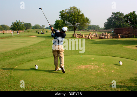 Golfer pose after driver's hit Stock Photo