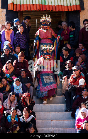 Buddhist mask dancers dressed as Mahakala coming down a set of stairs during the Thiksey Gustor festival in Ladakh Stock Photo