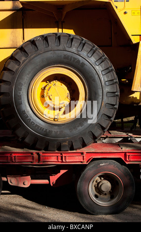 Big wheels on a front loader sitting idle in a road construction ...