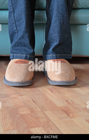 Man Wearing Sheepskin Comfy Slippers Whilst Sitting Down in a Leather ...