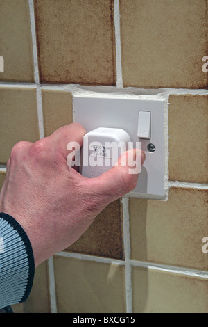 Caucasian Adult Male Plugging In / Unplugging an Electrical Three Pin Plug into a Wall Socket, UK MODEL RELEASED