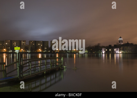 The winter-swimming quay in Tuira, Oulu, Finland, with science center Tietomaa and some apartment buildings in the background. Stock Photo