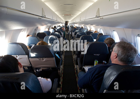 Airplane full of passengers sitting, from the rear of the plane Stock Photo