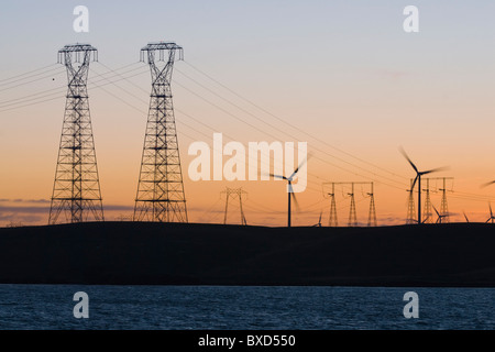 Wind turbines and power transmission lines at sunset near San Francisco Stock Photo