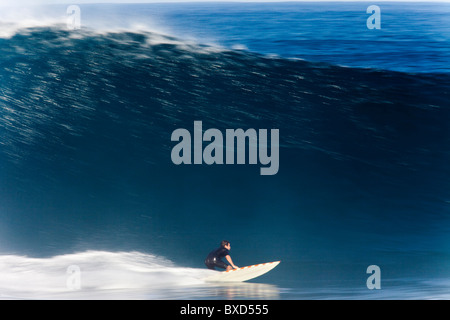 A surfer, captured in Speed Blur fashion at world famous Pipeline, on the north shore of Oahu, Hawaii. Stock Photo