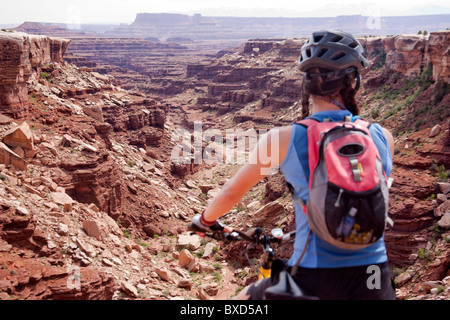 A woman bikes the White Rim trail in Utah. Stock Photo