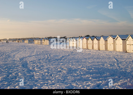 Snow on the beach with beach huts at Goring. Worthing. West Sussex. England. Unusual weather - snow not usual for this place Stock Photo