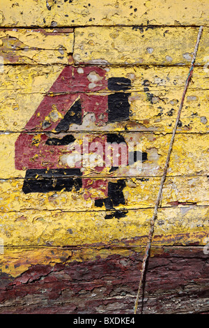 Number 4 and peeling paint on old fishing boat , Caldera , Chile Stock Photo