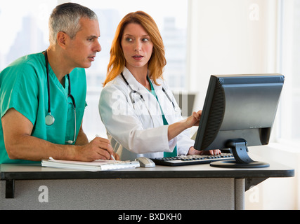 Healthcare professionals working at computer Stock Photo