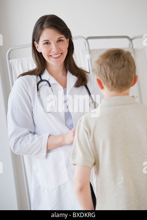 Young boy and doctor in examination room Stock Photo