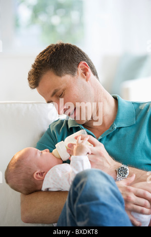 Father feeding his baby Stock Photo