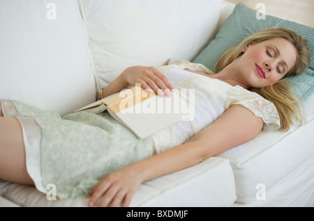 Woman resting on couch Stock Photo