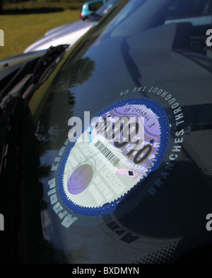 UK road tax disc on car windscreen Stock Photo