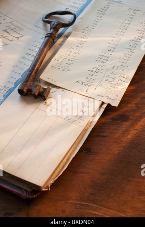 Antique key on top of ledger Stock Photo
