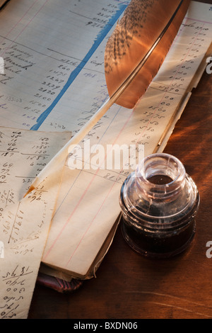 Ink feather pen and ledger Stock Photo