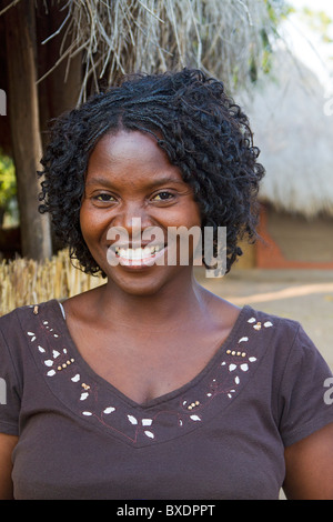 Beautiful young woman in early dawn light in her village, Kawaza, Zambia, Africa. She is of the Kunda tribe. Stock Photo