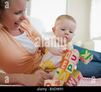 Mother and baby playing with blocks Stock Photo