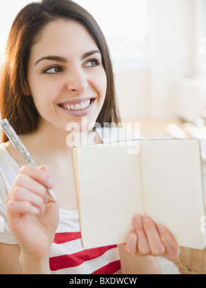 Brunette woman holding an empty notebook Stock Photo