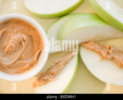 Peanut butter on sliced apple Stock Photo