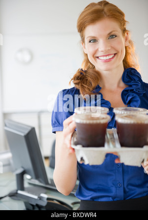 Businesswoman holding a tray of coffee Stock Photo