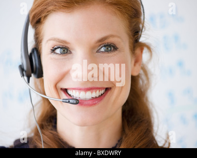 Cheerful businesswoman wearing headset Stock Photo