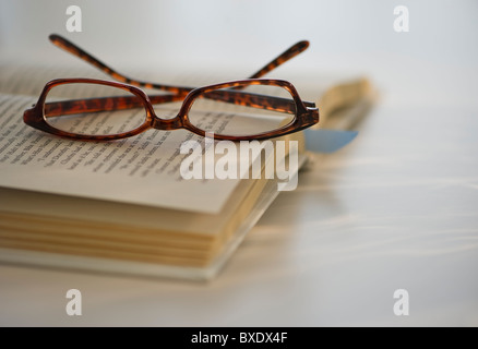 Reading glasses on book Stock Photo
